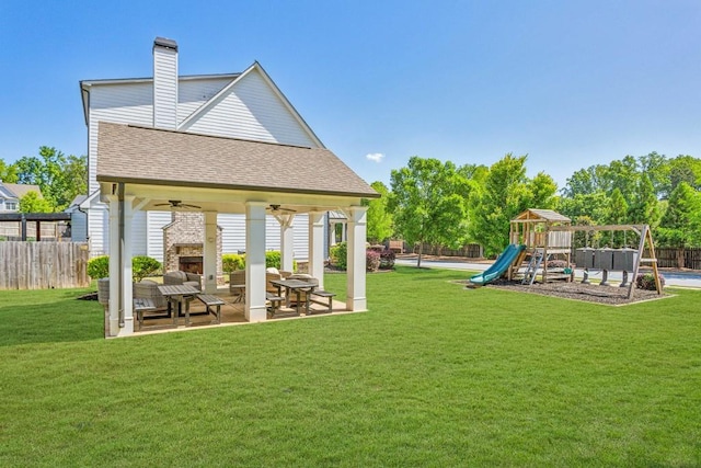 back of house featuring ceiling fan, a playground, roof with shingles, a patio, and a chimney