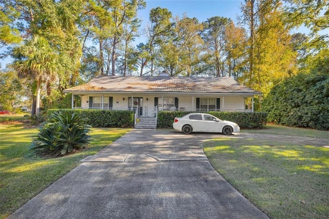 single story home with covered porch and a front yard