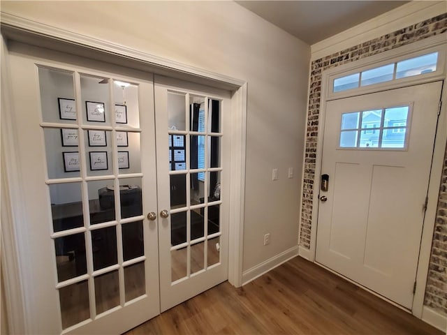 entryway featuring hardwood / wood-style floors and french doors