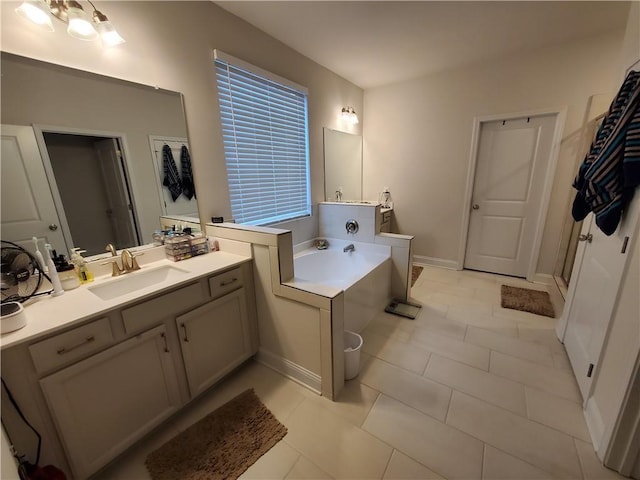 bathroom featuring vanity, a tub to relax in, and tile patterned floors