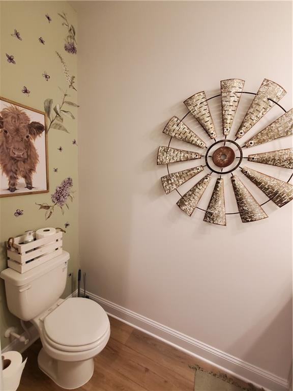 bathroom featuring hardwood / wood-style floors and toilet