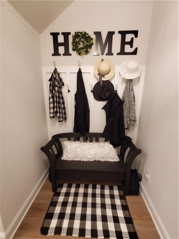 mudroom with hardwood / wood-style flooring and lofted ceiling