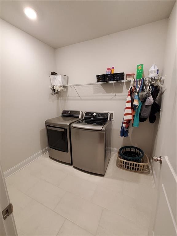 clothes washing area featuring washer and clothes dryer