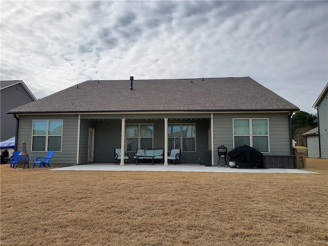 back of property featuring an outdoor hangout area, a patio area, and a lawn