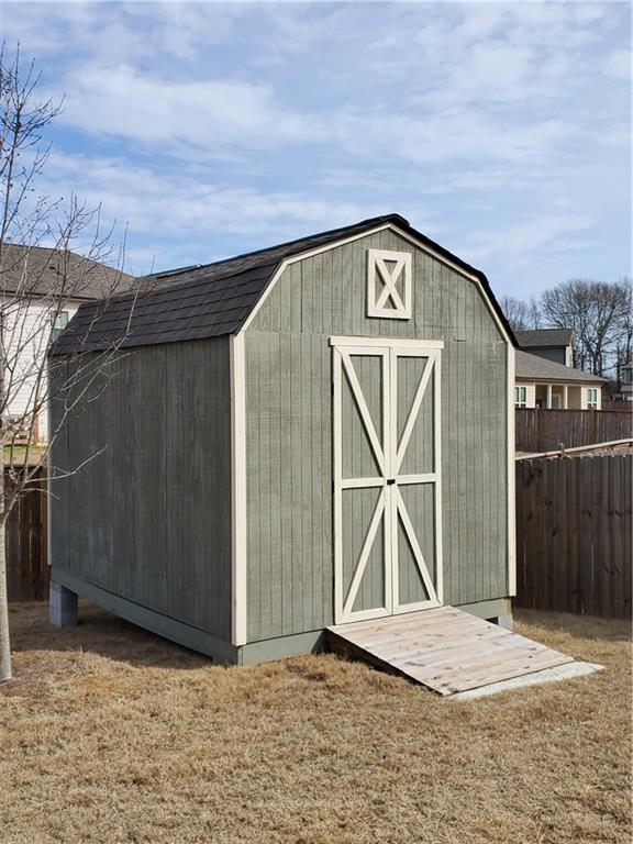 view of outdoor structure featuring a lawn