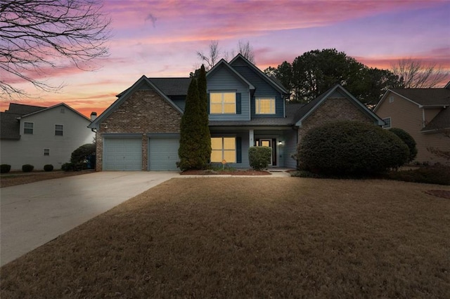 front facade with a garage and a lawn