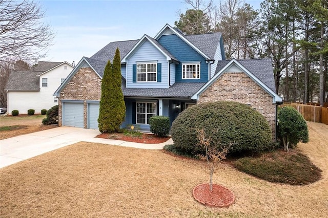 view of front of house with a garage and a front lawn