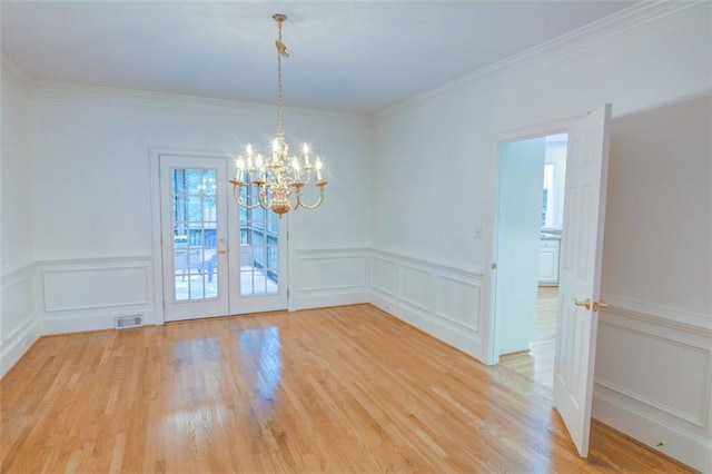 5404 Chaversham Ln, Peachtree Corners, GA 30092 - unfurnished room featuring a decorative wall, a chandelier, light wood-type flooring, ornamental molding, and a wainscoted wall