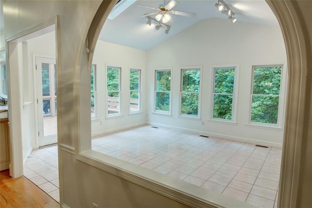 5404 Chaversham Ln, Peachtree Corners, GA 30092 - empty room with ceiling fan, lofted ceiling, track lighting, arched walkways, and light tile patterned floors