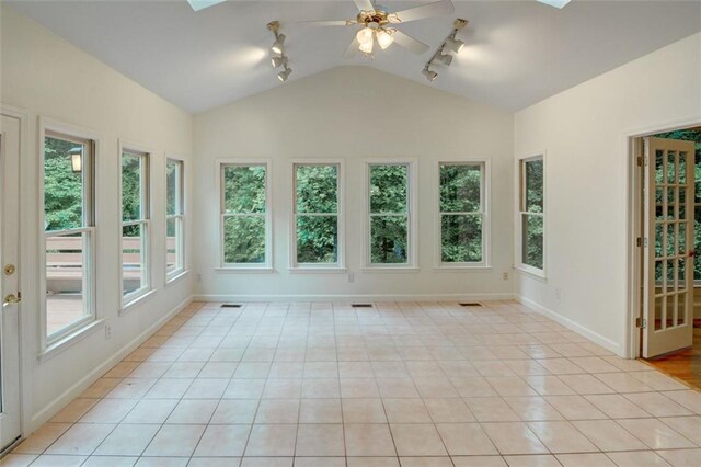 5404 Chaversham Ln, Peachtree Corners, GA 30092 - unfurnished sunroom with rail lighting, lofted ceiling, plenty of natural light, and baseboards