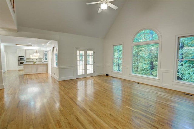 5404 Chaversham Ln, Peachtree Corners, GA 30092 - unfurnished living room with high vaulted ceiling, ceiling fan, light wood finished floors, and a decorative wall