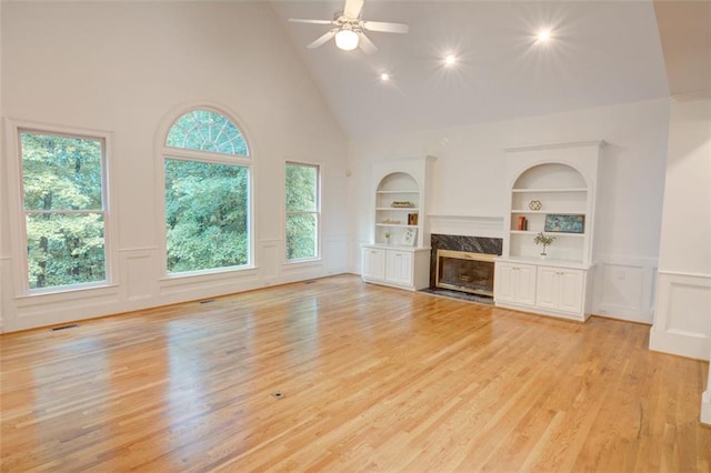 5404 Chaversham Ln, Peachtree Corners, GA 30092 - unfurnished living room featuring high vaulted ceiling, light wood-style flooring, built in features, a fireplace, and ceiling fan