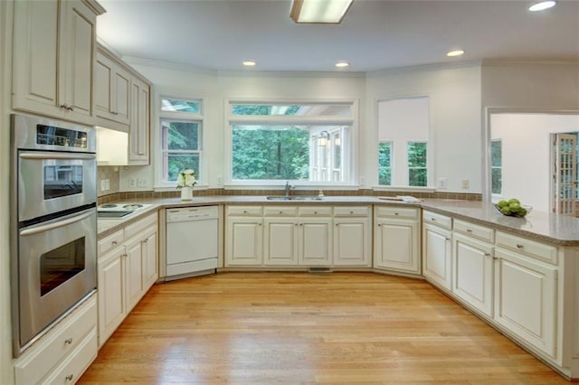 5404 Chaversham Ln, Peachtree Corners, GA 30092 - kitchen featuring white dishwasher, stainless steel double oven, a sink, crown molding, and plenty of natural light