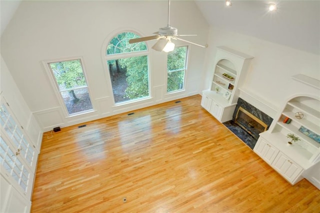 5404 Chaversham Ln, Peachtree Corners, GA 30092 - unfurnished living room featuring a fireplace, high vaulted ceiling, wood finished floors, and ceiling fan