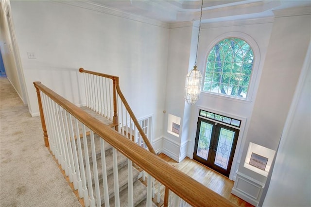5404 Chaversham Ln, Peachtree Corners, GA 30092 - carpeted foyer featuring a chandelier, crown molding, french doors, and a high ceiling