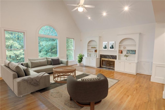 5404 Chaversham Ln, Peachtree Corners, GA 30092 - living area with high vaulted ceiling, healthy amount of natural light, built in shelves, light wood finished floors, and ceiling fan