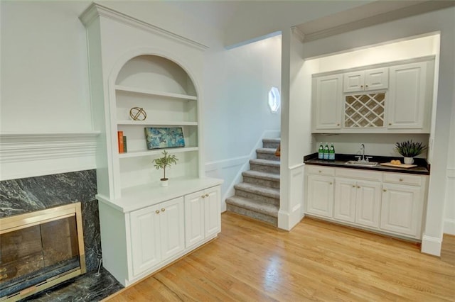 5404 Chaversham Ln, Peachtree Corners, GA 30092 - indoor wet bar featuring a high end fireplace, stairway, light wood-style floors, and built in features