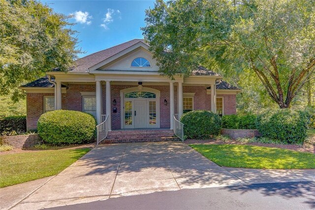 5404 Chaversham Ln, Peachtree Corners, GA 30092 - view of front of home with a porch, brick siding, and a front yard
