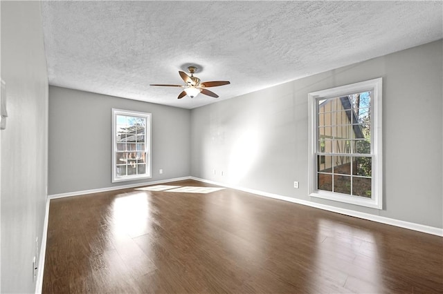 spare room featuring ceiling fan, a textured ceiling, and dark hardwood / wood-style flooring