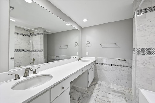 bathroom with vanity and tile walls