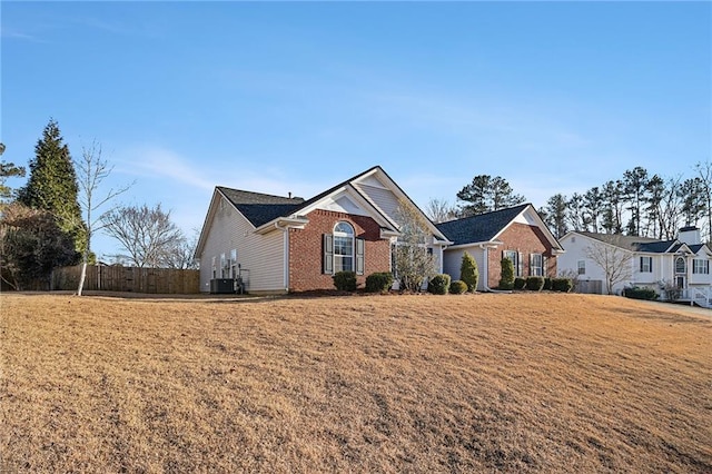 view of front of property featuring cooling unit and a front lawn