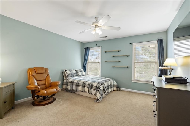 bedroom with light carpet, baseboards, multiple windows, and visible vents