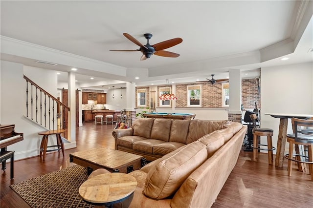 living area with crown molding, dark wood finished floors, pool table, visible vents, and stairs