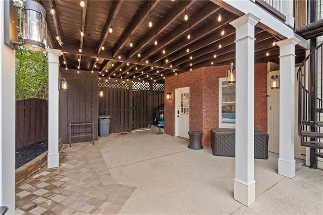 view of patio with a gate and fence