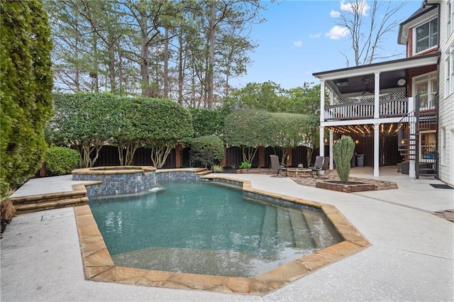 view of swimming pool featuring an outdoor fire pit, stairway, a patio area, and a fenced backyard