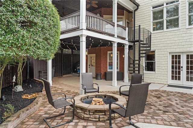 view of patio / terrace featuring stairs, french doors, an outdoor fire pit, and fence