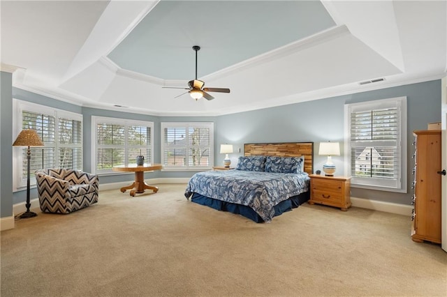 bedroom featuring ornamental molding, a tray ceiling, visible vents, and light carpet