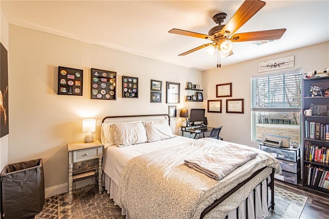 bedroom with dark wood-style flooring, a ceiling fan, and baseboards