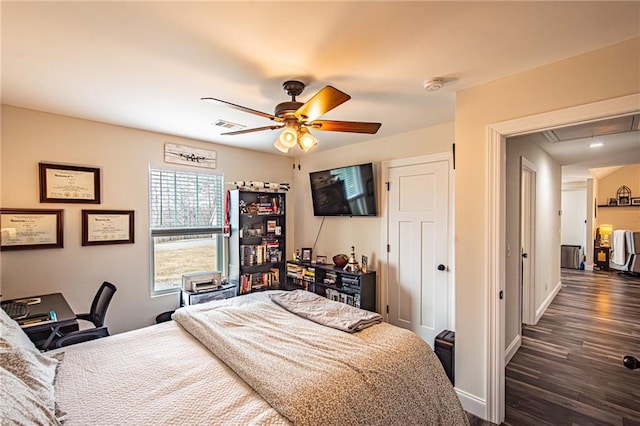 bedroom featuring attic access, baseboards, visible vents, a ceiling fan, and dark wood-type flooring