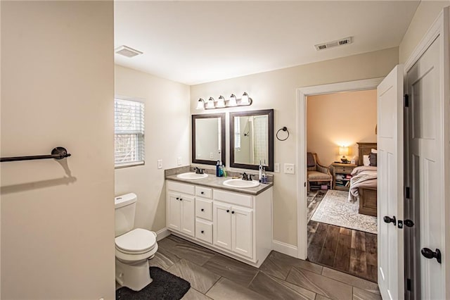 bathroom featuring ensuite bathroom, toilet, a sink, and visible vents