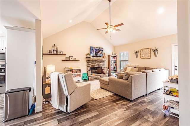 living room featuring a ceiling fan, a fireplace, high vaulted ceiling, and wood finished floors