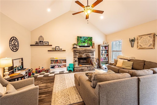 living room featuring ceiling fan, high vaulted ceiling, a fireplace, and wood finished floors