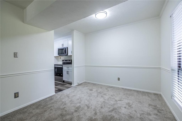 223 Tuxworth Cir, Decatur, GA 30033 - spare room featuring baseboards, ornamental molding, and carpet flooring