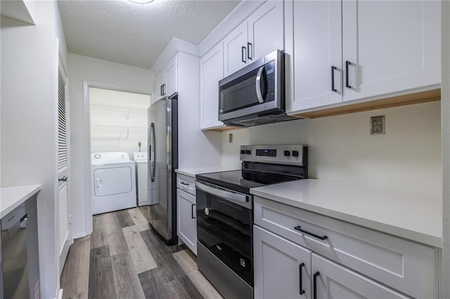 223 Tuxworth Cir, Decatur, GA 30033 - kitchen with light countertops, appliances with stainless steel finishes, independent washer and dryer, and wood finished floors