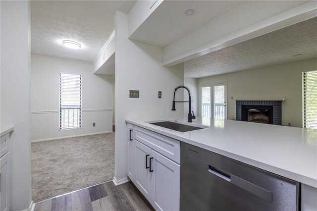 223 Tuxworth Cir, Decatur, GA 30033 - kitchen with a textured ceiling, dishwasher, a sink, light countertops, and open floor plan