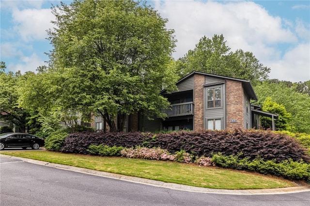 223 Tuxworth Cir, Decatur, GA 30033 - view of front of home featuring brick siding, a balcony, and a front yard