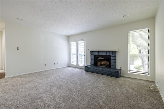 223 Tuxworth Cir, Decatur, GA 30033 - unfurnished living room with baseboards, a textured ceiling, carpet, and a brick fireplace