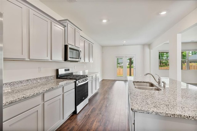 4117 Flat Rock Pt, Stonecrest, GA 30038 - kitchen with stainless steel appliances, a sink, dark wood-style floors, recessed lighting, and light stone countertops