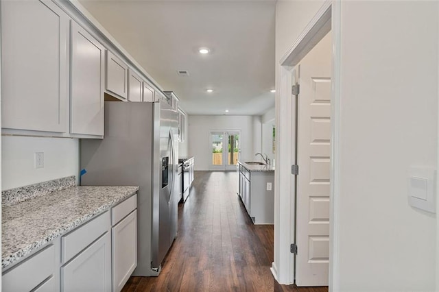 4117 Flat Rock Pt, Stonecrest, GA 30038 - kitchen with a sink, recessed lighting, dark wood-type flooring, stainless steel refrigerator with ice dispenser, and light stone countertops