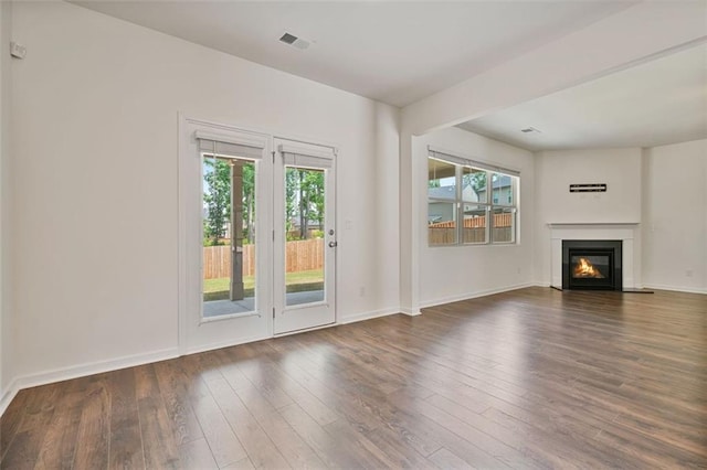 4117 Flat Rock Pt, Stonecrest, GA 30038 - unfurnished living room with wood-type flooring, a glass covered fireplace, and baseboards