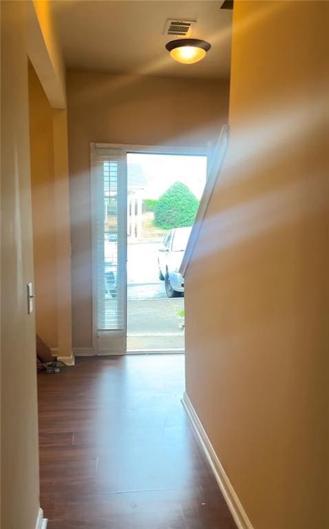 hallway with dark hardwood / wood-style flooring