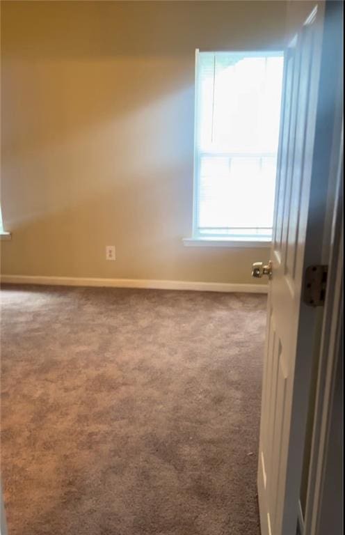 unfurnished room featuring carpet