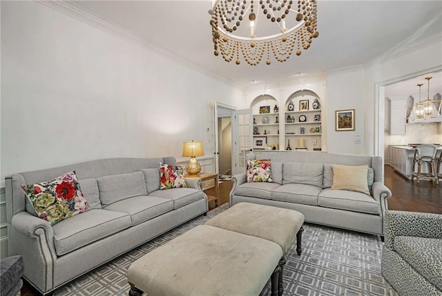 living room featuring built in shelves, crown molding, and a notable chandelier