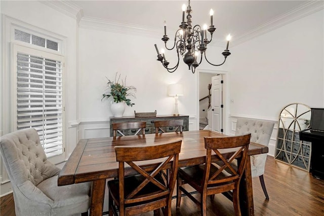 dining room with crown molding, dark hardwood / wood-style floors, and a chandelier