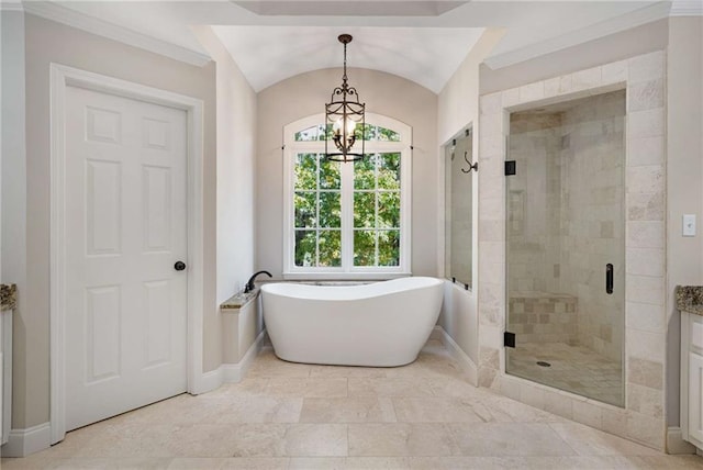 bathroom featuring vanity, vaulted ceiling, a notable chandelier, and separate shower and tub