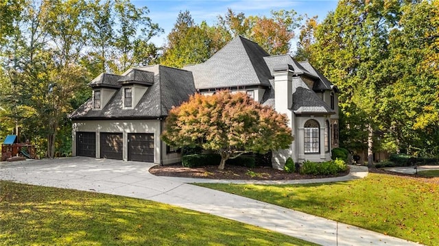 view of front of house featuring a garage and a front lawn